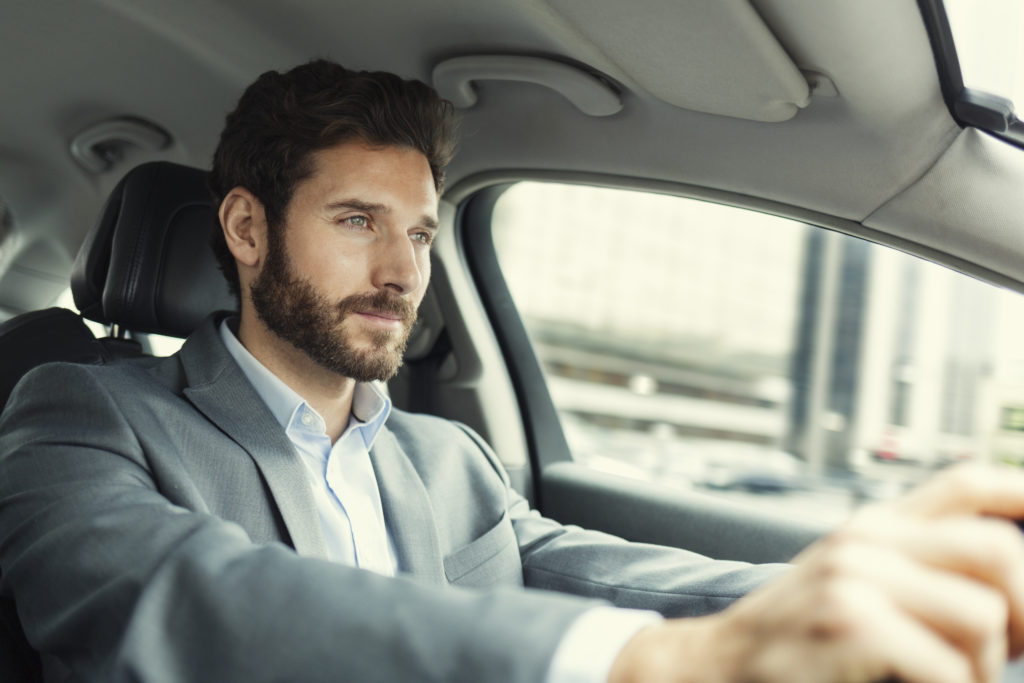 Handsome man in a car drive